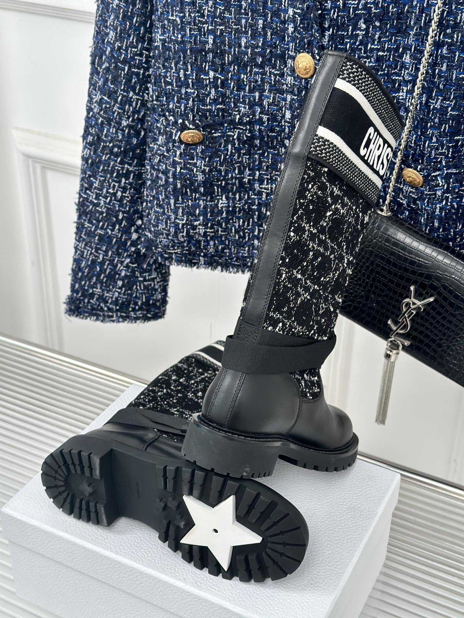 Black sole view of ankle boots with tread, paired with patterned fabric shaft