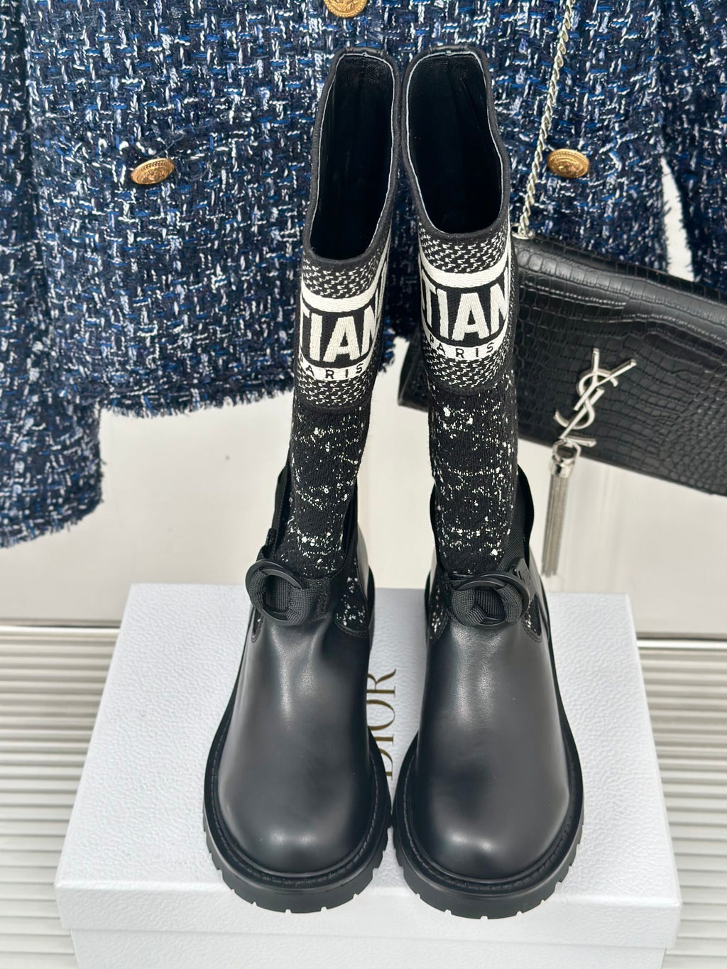Black ankle boots with patterned sock-style tops and Dior logo band trim