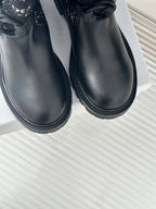 Black leather ankle boots with thick tread sole and rounded toe