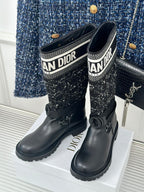 Pair of black boots with patterned fabric shaft and Dior logo trim, low heel