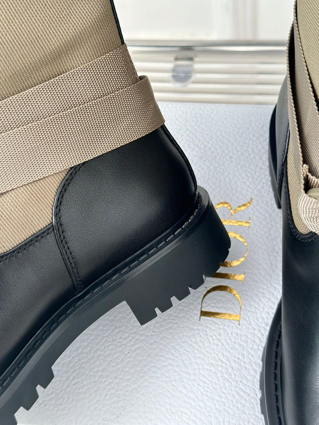 Women’s Dior ankle boots detail, black rubber sole and beige cuff with stitched trim