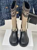 Women’s Dior ankle boots front view, beige knit shaft and black leather with buckle straps