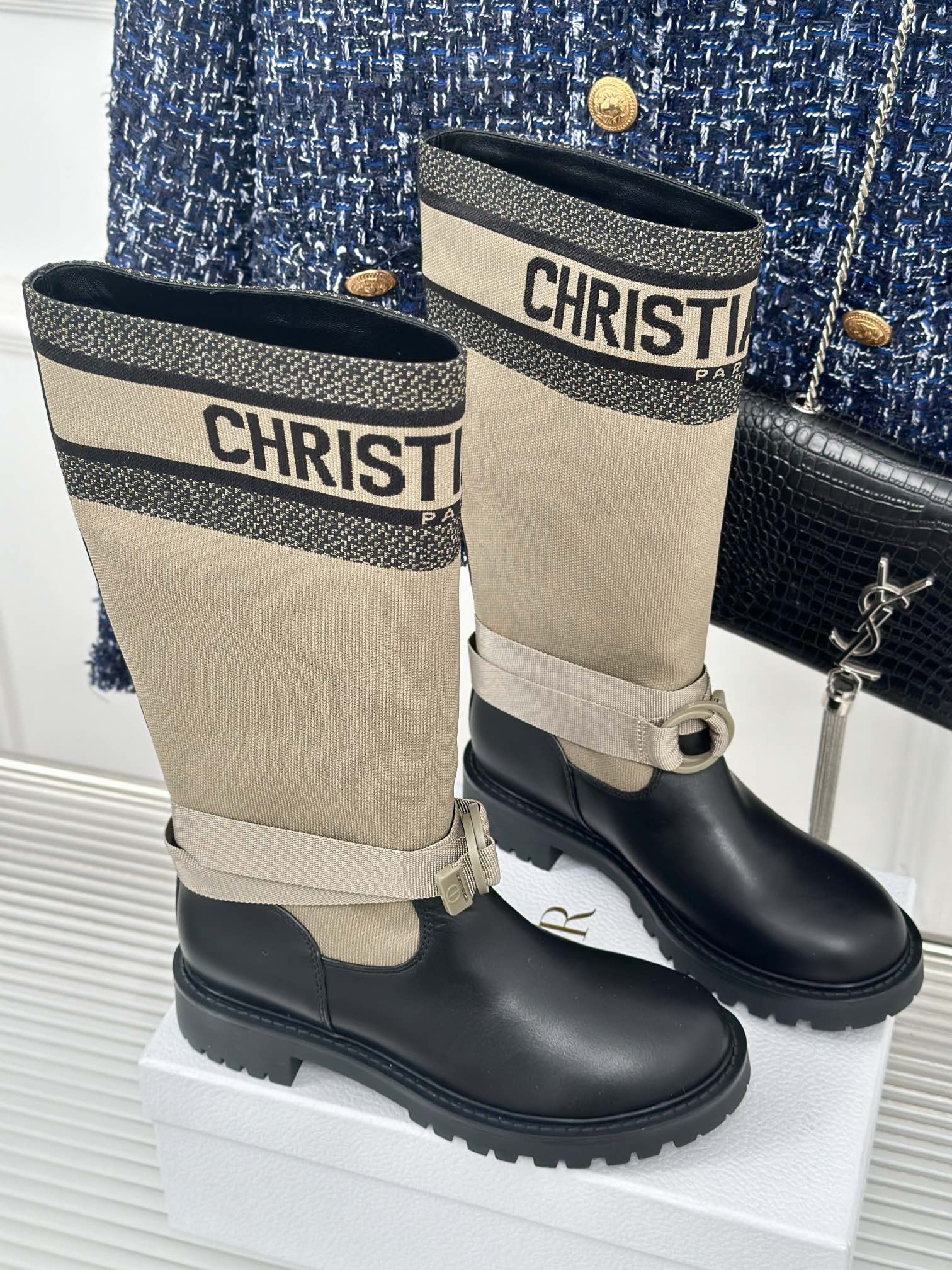 Women’s Dior ankle boots pair, beige cuff with logo band and black lace-up style