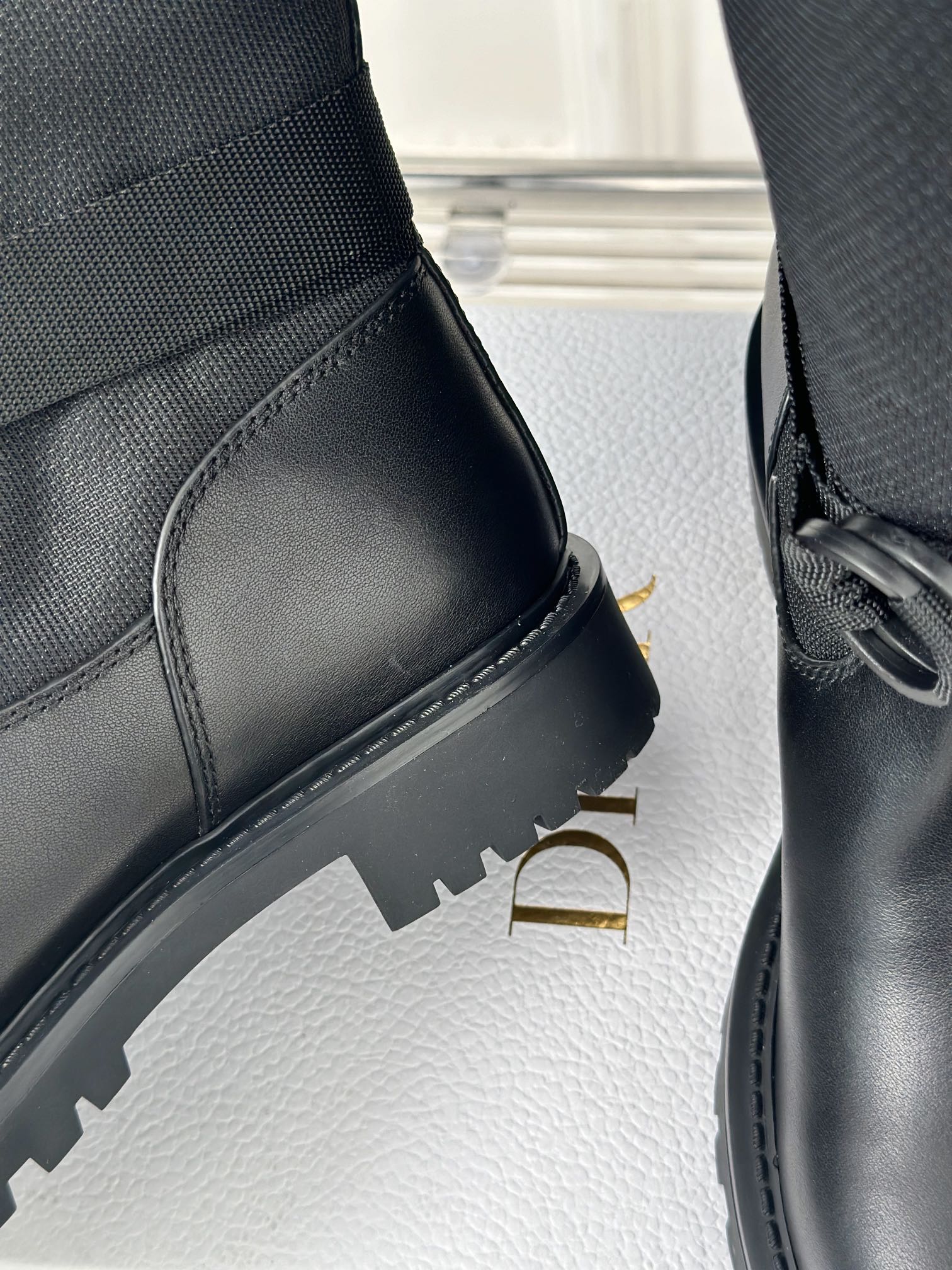 Black boot with stitched panel and chunky rubber sole