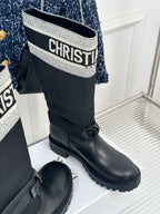 Black knee-high boots with logo cuff and front buckle strap
