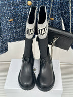 Black knee-high boots with logo socks and chunky rubber soles