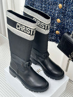 Black ankle boots with patterned logo collar and side bow detail