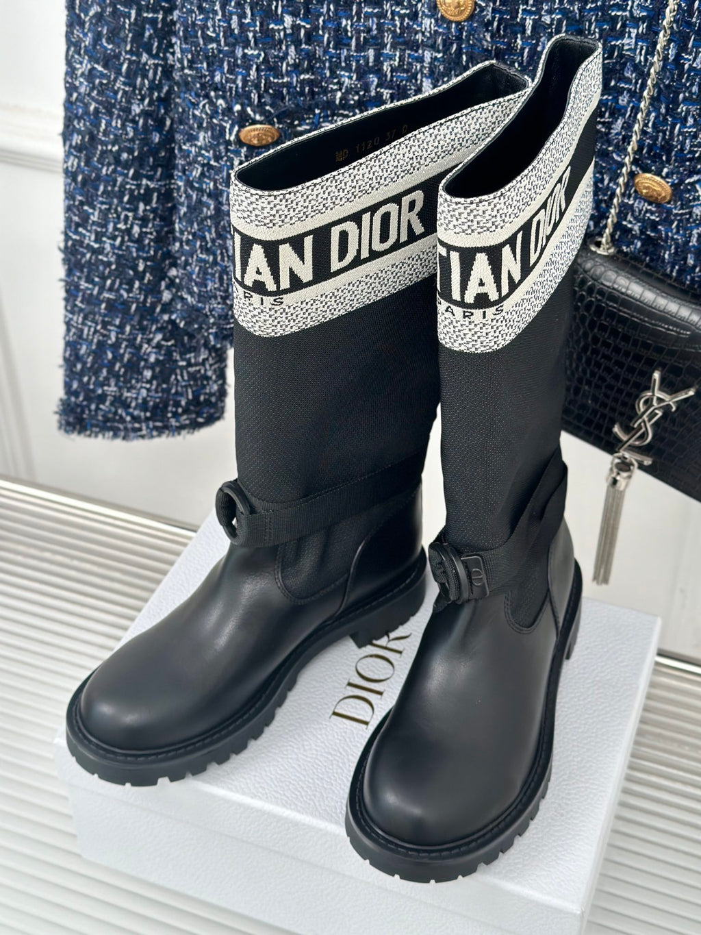 Black knee-high boots with logo knit cuff and lace-up detail