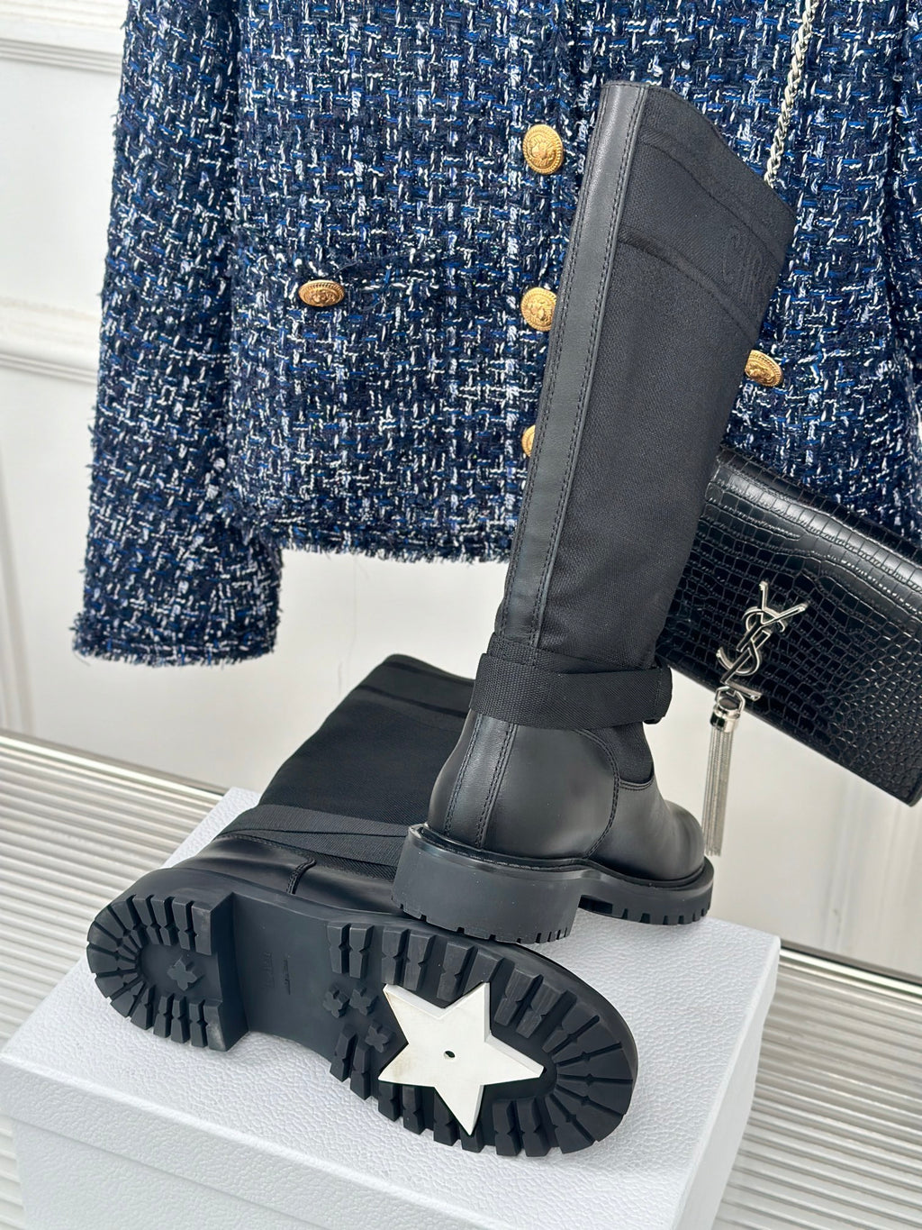 Dior ladies black leather boots with strap details, outsole tread visible