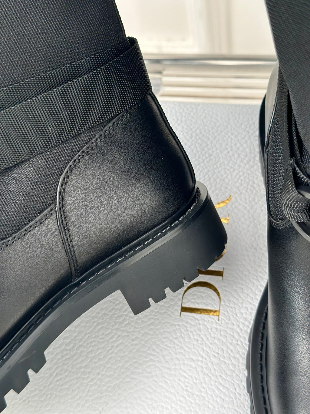 Dior ladies black leather boot side and heel, showing ridged rubber sole