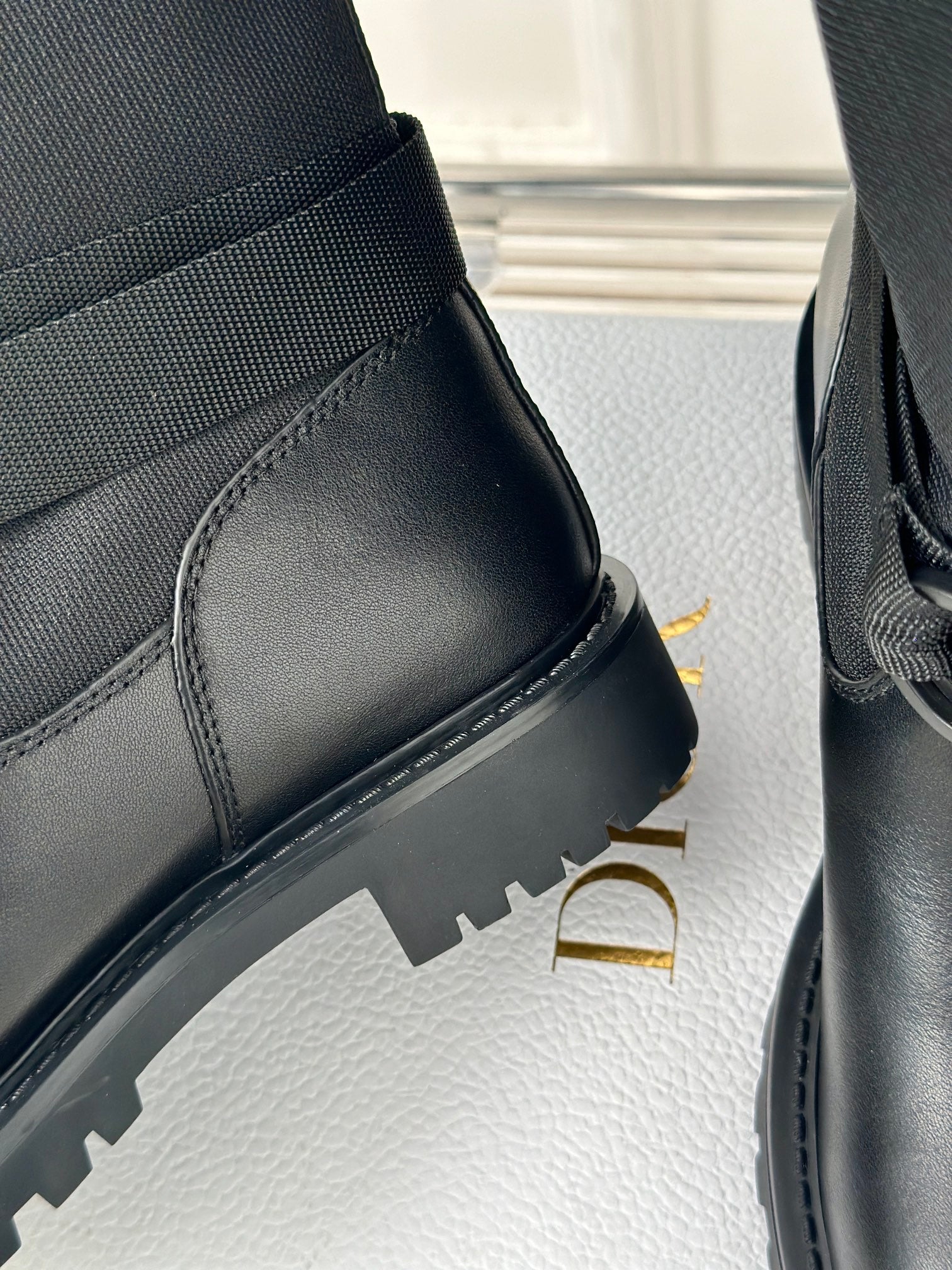 Dior ladies black leather boot side and heel, showing ridged rubber sole
