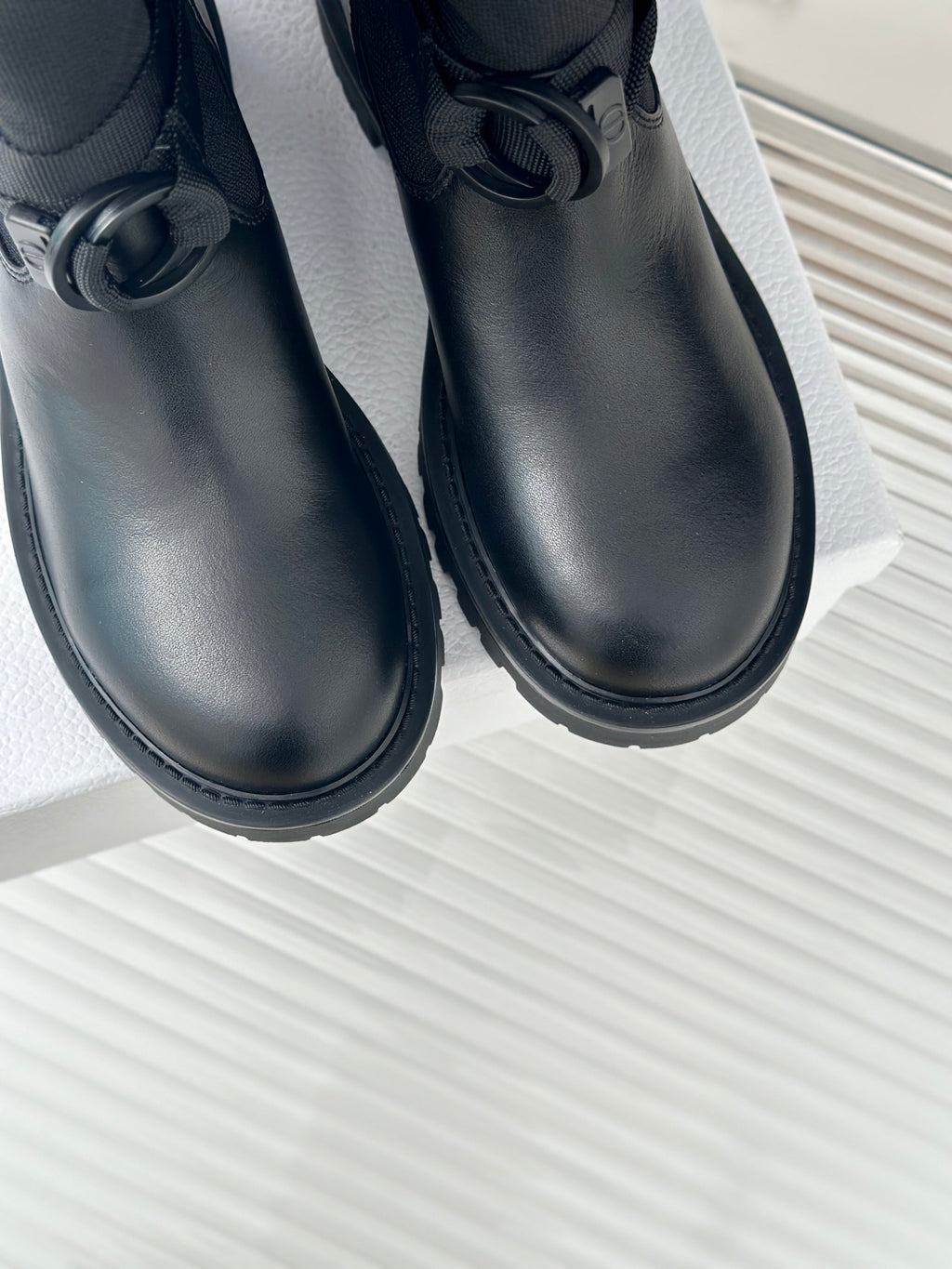 Dior ladies black leather boots, front view, with tie detail and tread sole