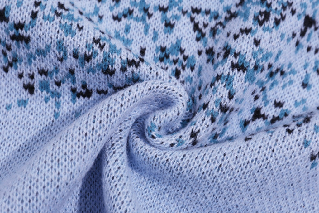 Light blue knit sweater fabric detail with speckled graphic pattern