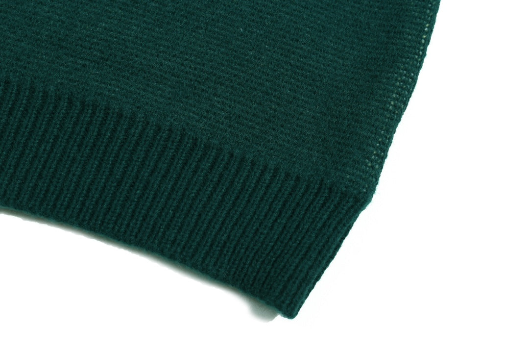Green ribbed knit cuff detail on sweater sleeve