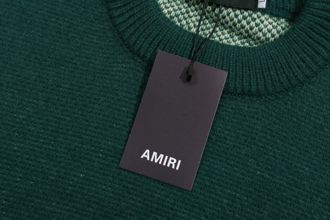 Green knit sweater neckline with AMIRI hanging tag