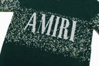 Green sweater with large AMIRI logo across speckled knit band