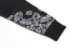 Black sleeve cuff with white jacquard pattern and ribbed knit trim