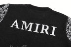 Black sweater back with large white AMIRI text and jacquard band at hem