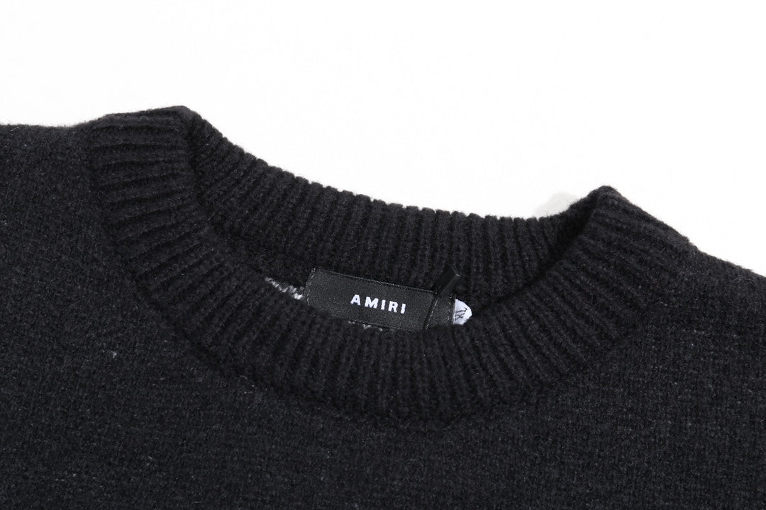Black knit sweater neckline with ribbed collar and small AMIRI label