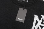 Black knit sweater with AMIRI neck label and hanging price tag