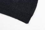 Dark knit sweater hem with ribbed cuff edge