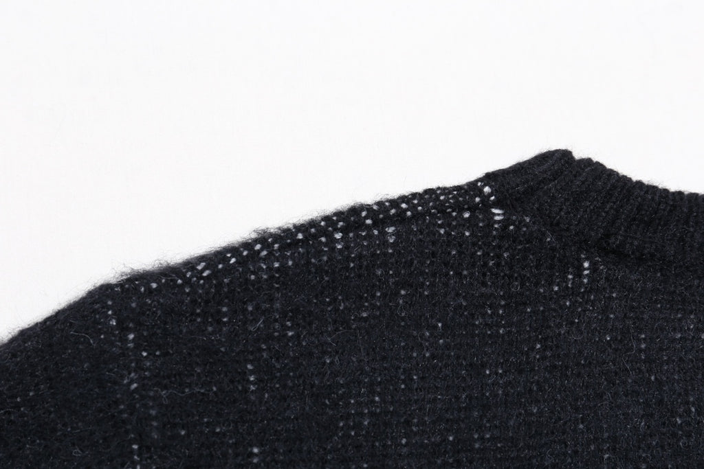 Dark knit sweater shoulder and neckline close-up, ribbed collar