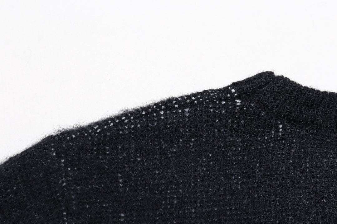Dark knit sweater shoulder and neckline close-up, ribbed collar
