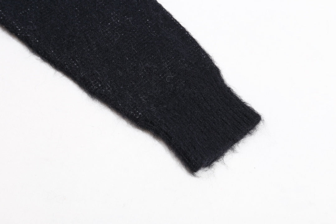 Dark knit sweater sleeve with ribbed cuff detail