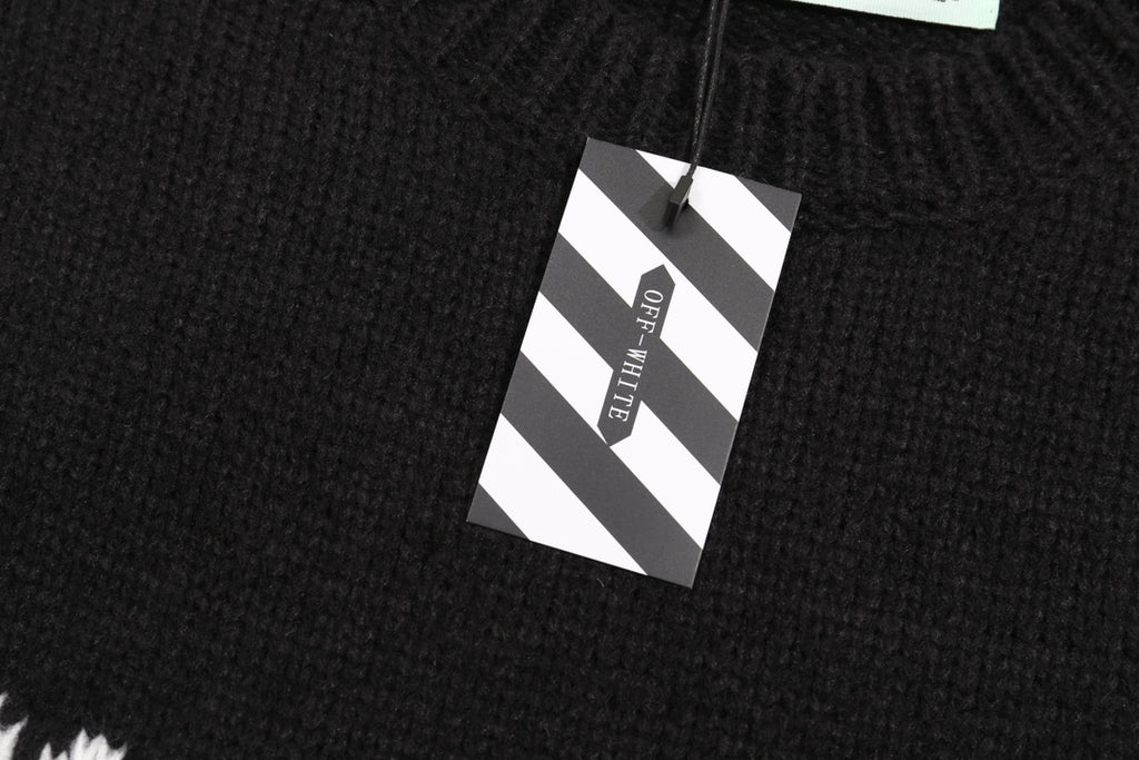 Black knit sweater hem with hanging size tag