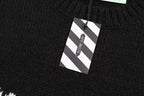 Black knit sweater hem with hanging size tag