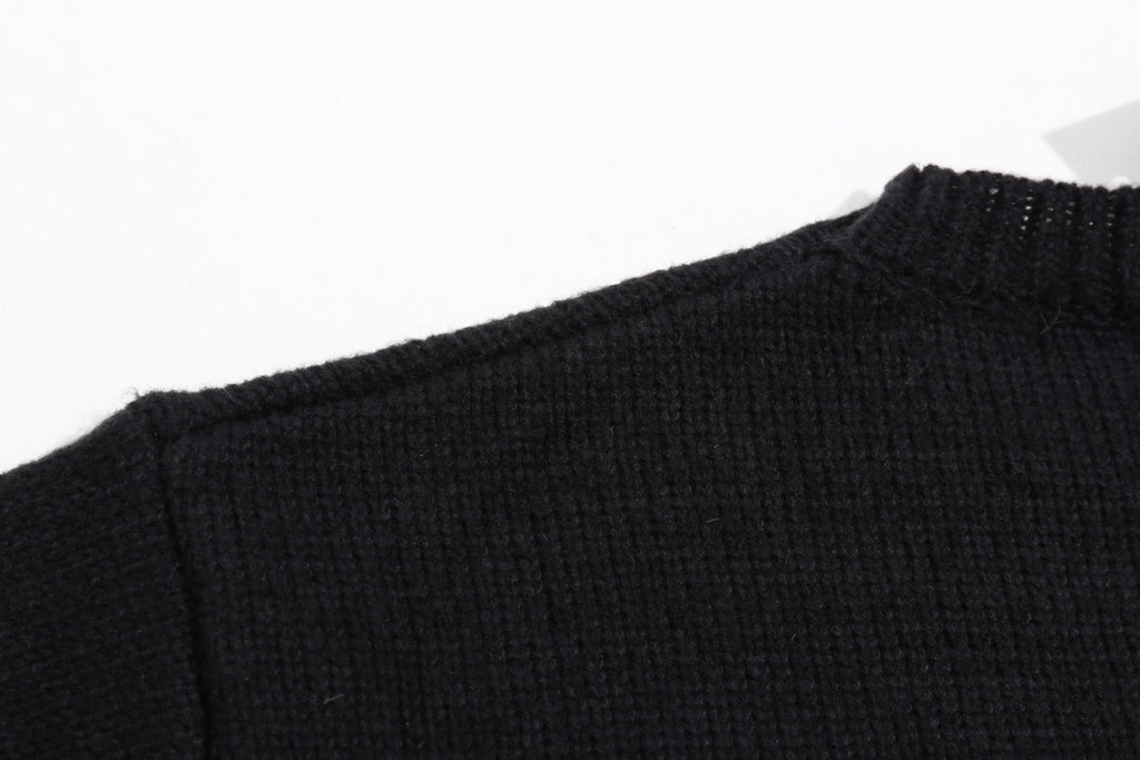 Black knit sweater neckline and shoulder seam with ribbed collar