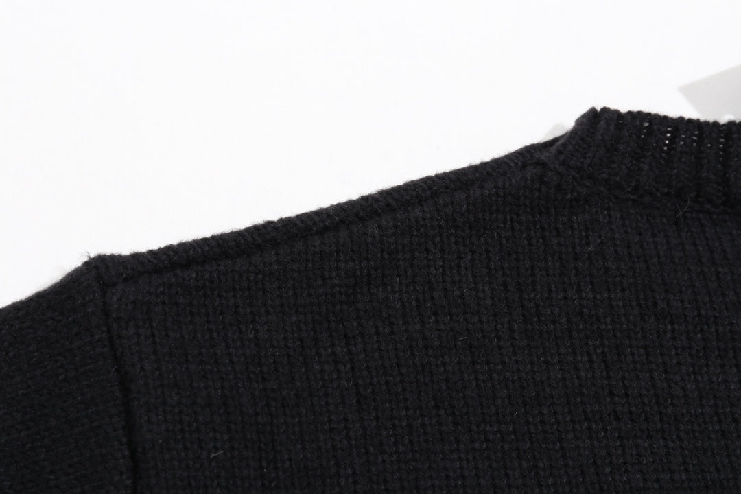 Black knit sweater neckline and shoulder seam with ribbed collar