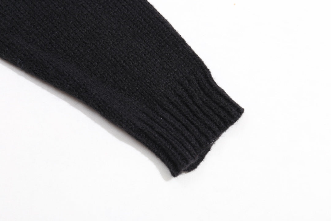 Black ribbed knit sweater cuff at sleeve end