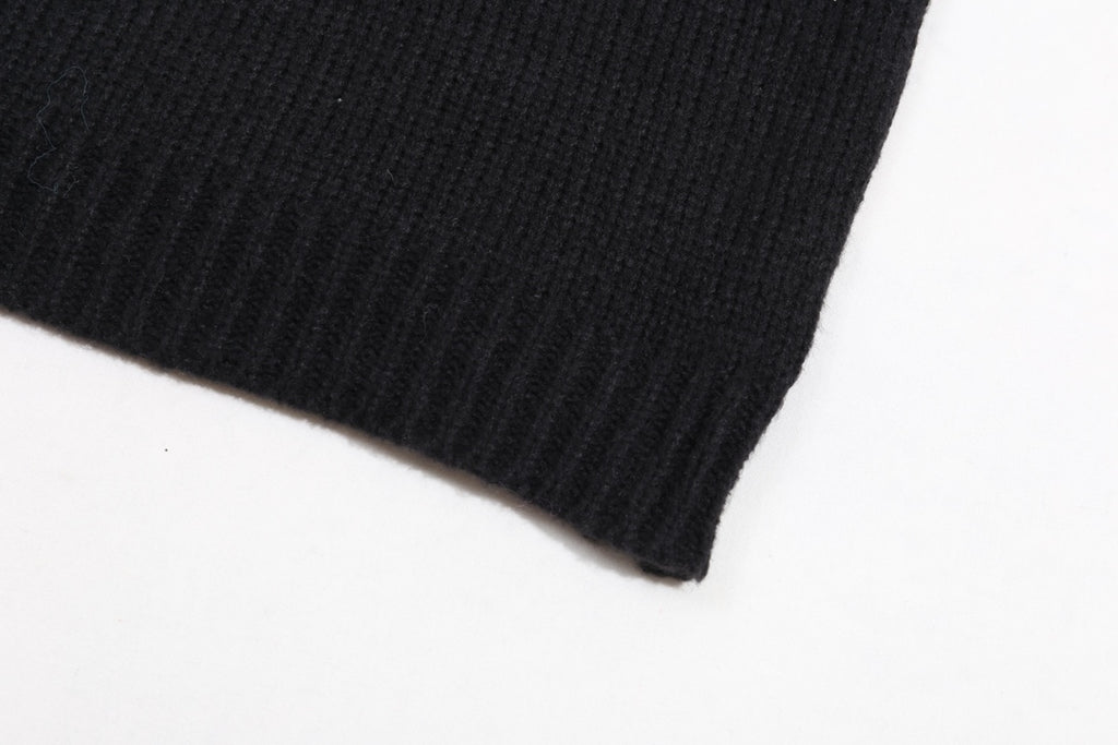 Black ribbed sweater hem and sleeve cuff detail