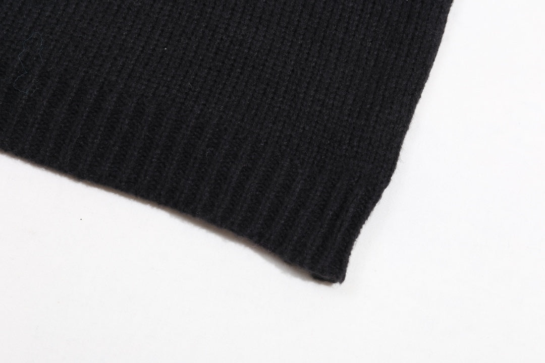 Black ribbed sweater hem and sleeve cuff detail