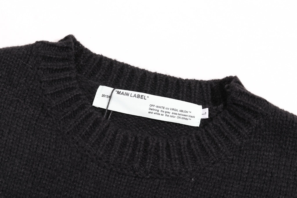 Black crewneck knit sweater with interior label near neckline