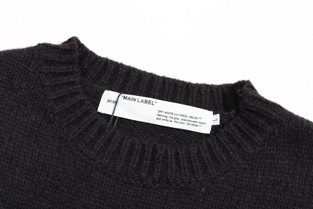 Black crewneck knit sweater with interior label near neckline