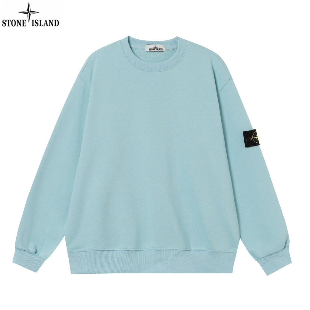 Light blue crewneck sweatshirt with ribbed cuffs and a black sleeve patch