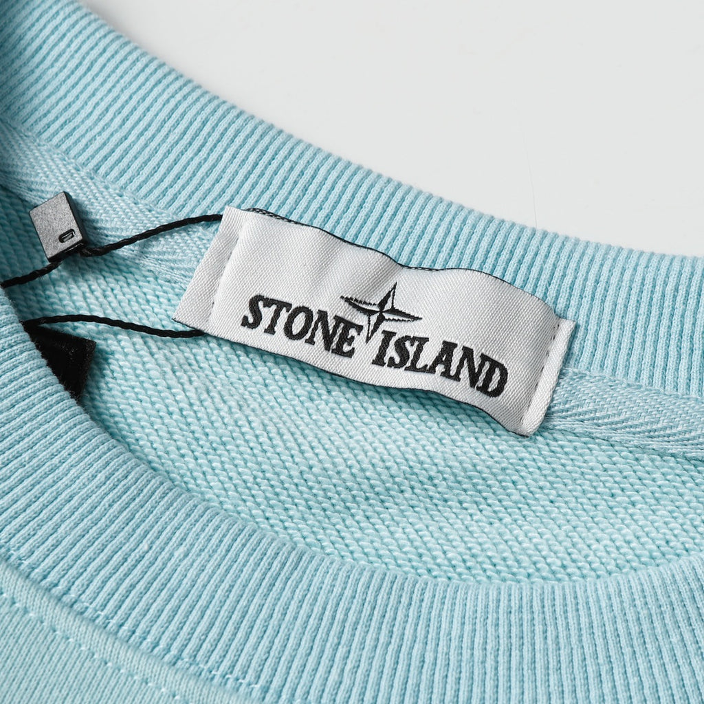Light blue crewneck sweatshirt collar with woven neck label