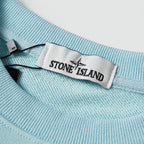 Light blue crewneck sweatshirt collar with woven neck label