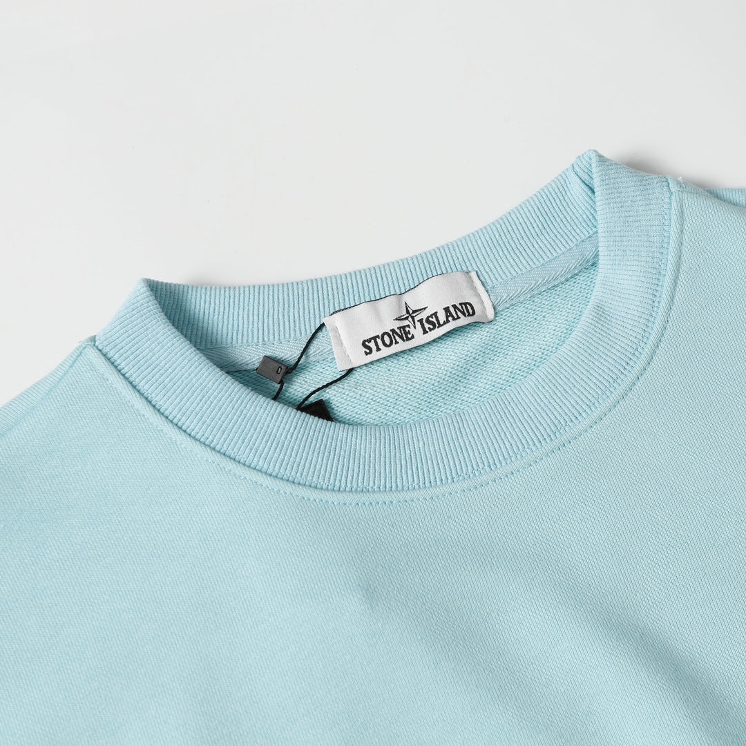Light blue crewneck sweatshirt neckline with inner brand neck label