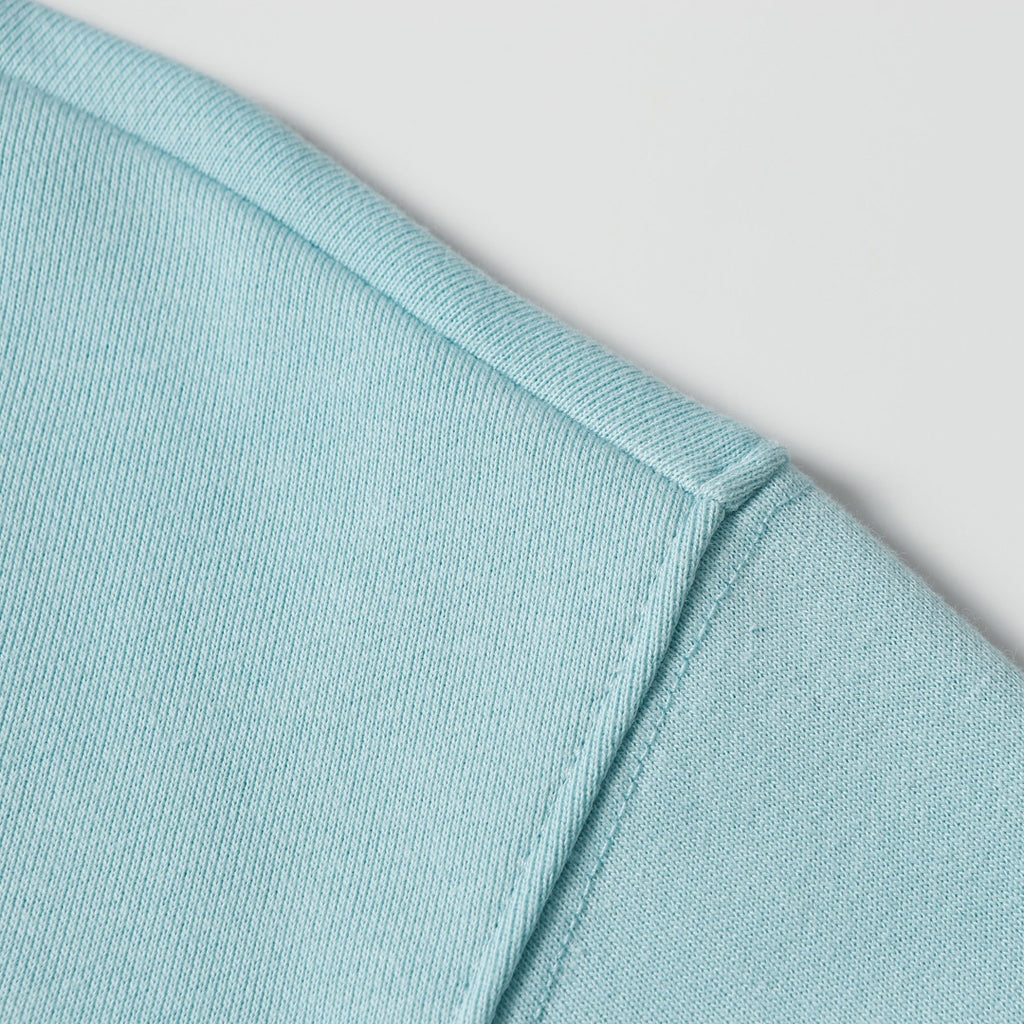 Light blue sweatshirt shoulder and collar ribbing detail