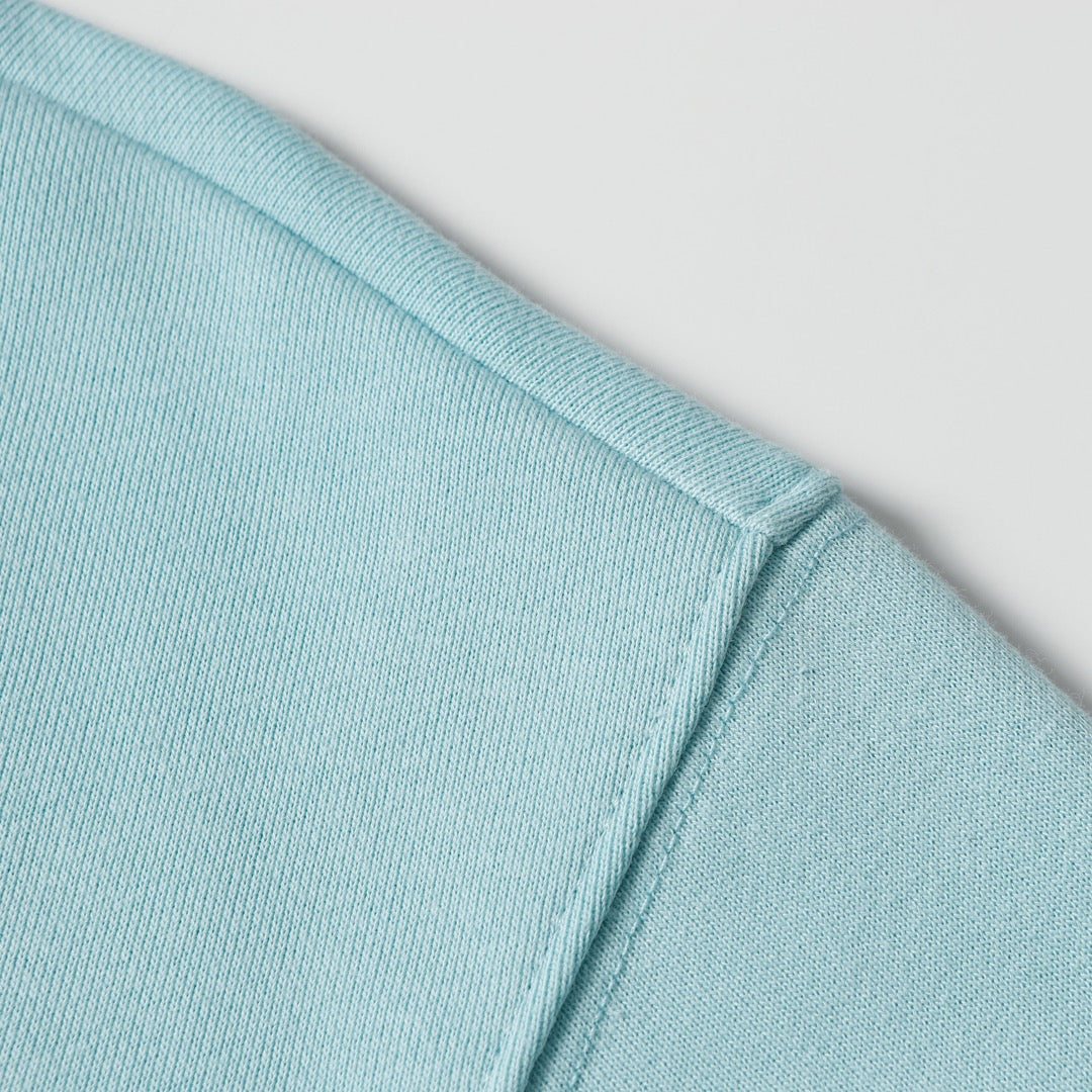Light blue sweatshirt shoulder and collar ribbing detail