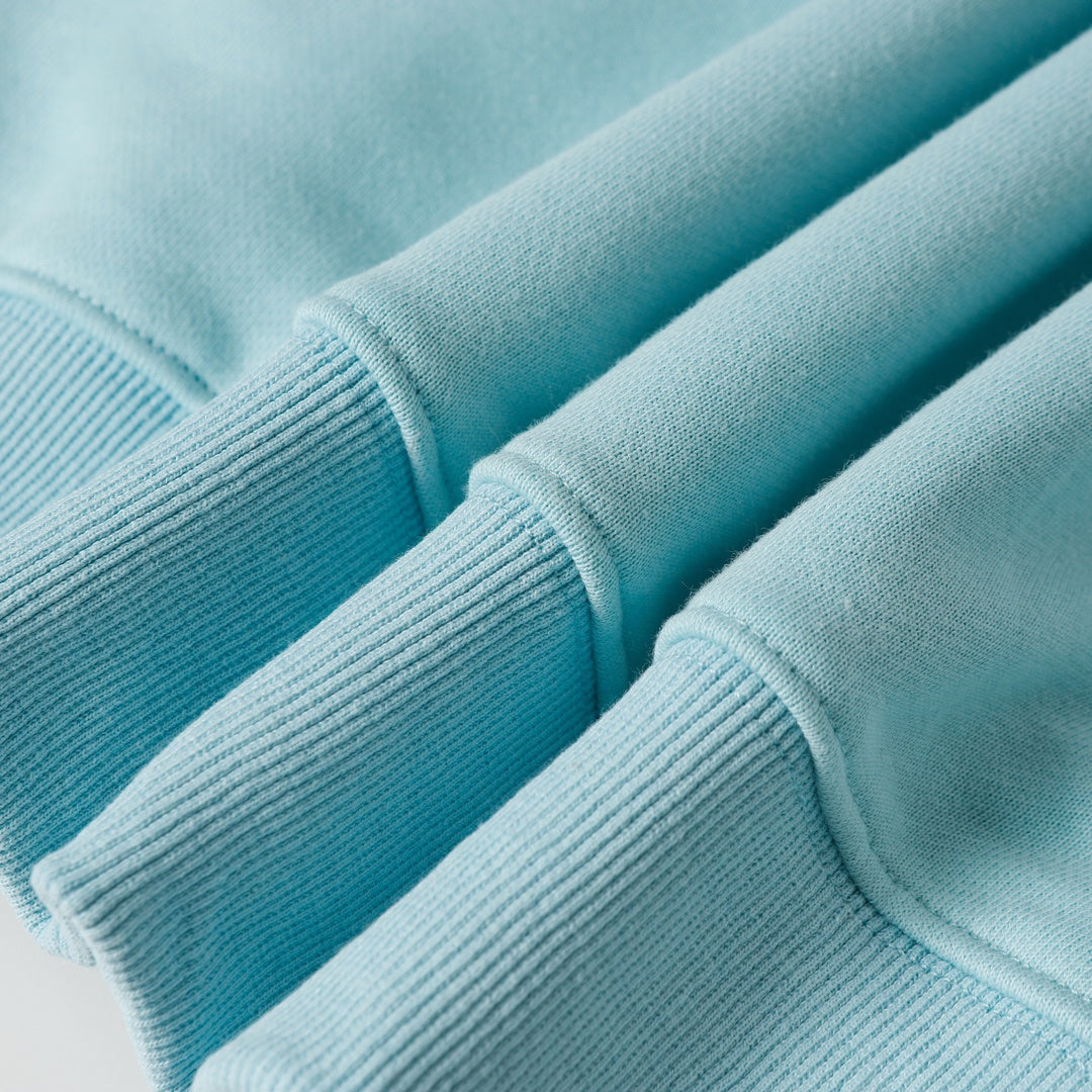 Light blue ribbed sweatshirt cuffs and sleeve fabric texture