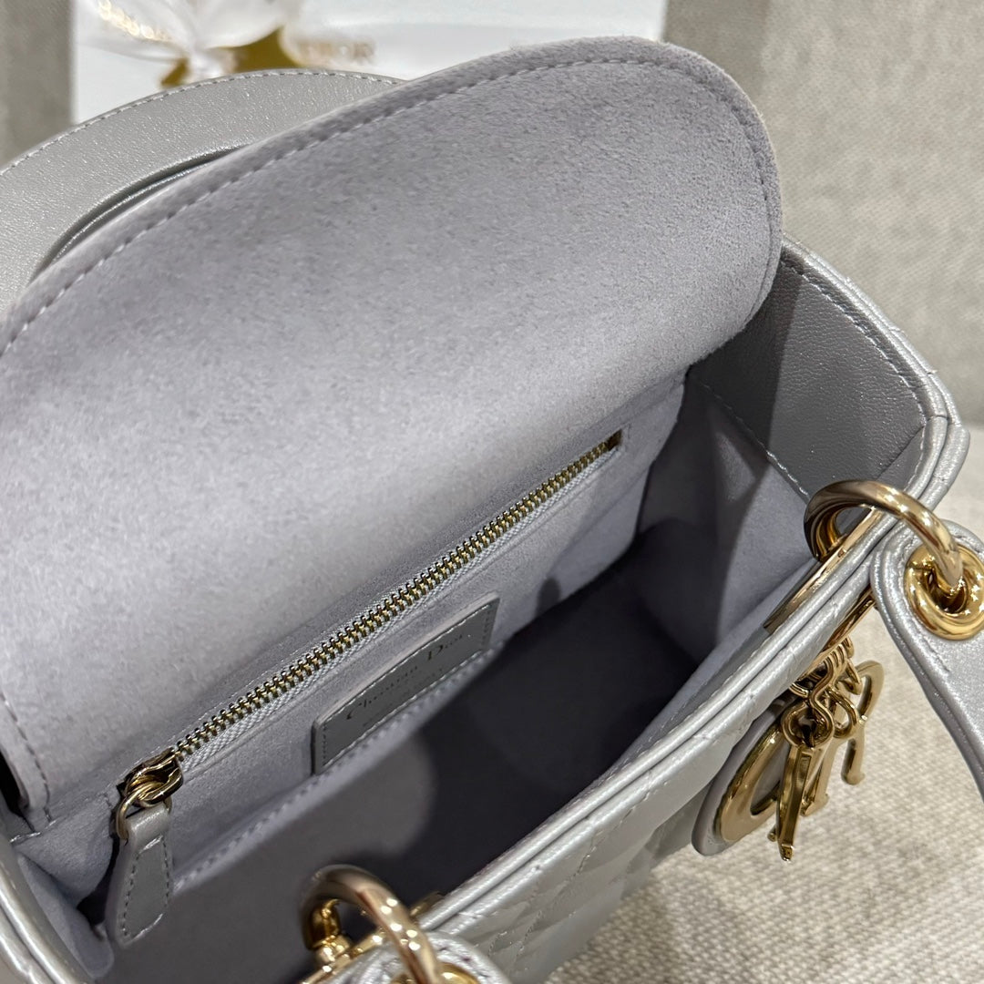Dior quilted handbag interior with zipper pocket and gold hardware in light gray