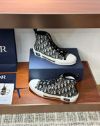 Dior high-top sneakers on display box, black-and-white monogram canvas, lace-up