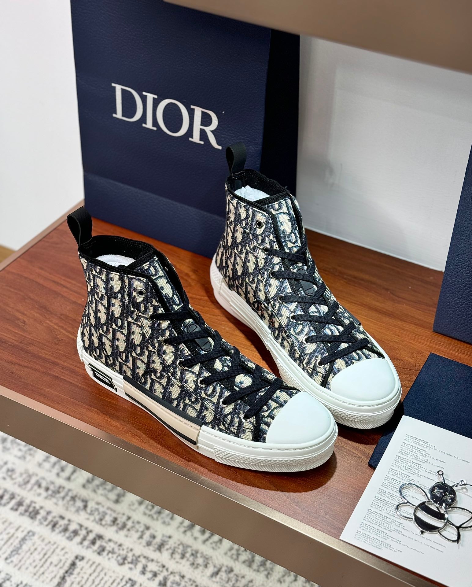 Dior high-top sneakers, black-and-white monogram pattern, white rubber toe cap