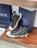 Dior high-top sneakers with black-and-white monogram print, front lace-up view