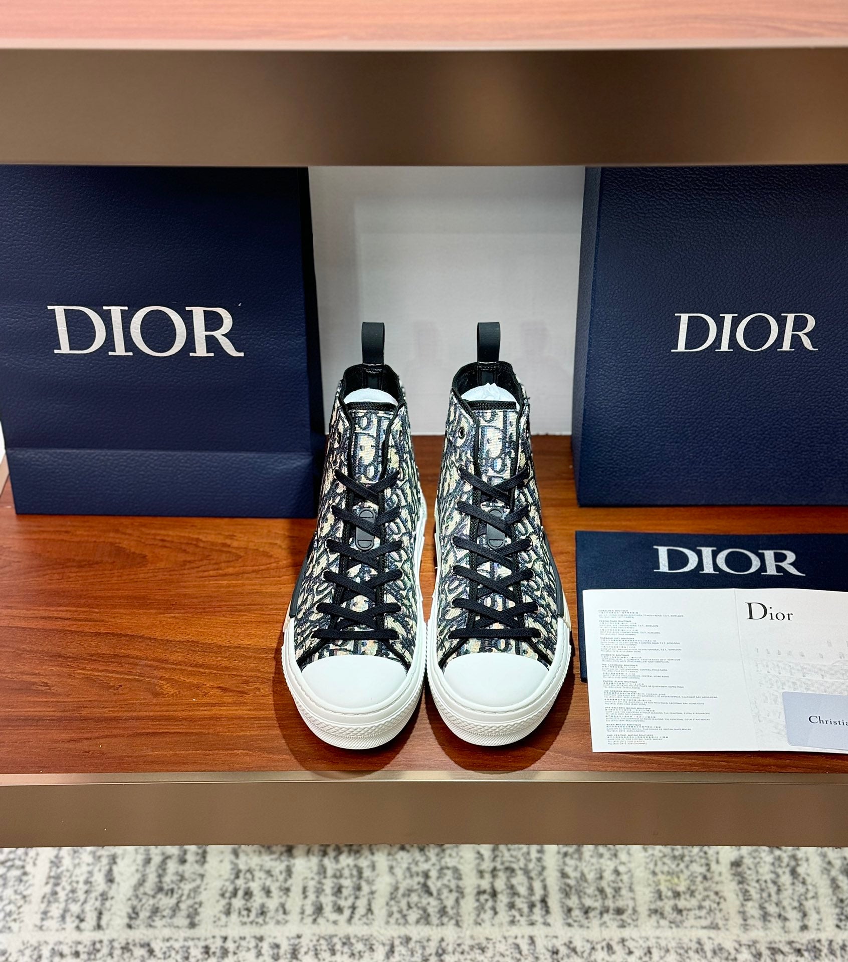Dior high-top sneakers with black-and-white monogram canvas, lace-up front