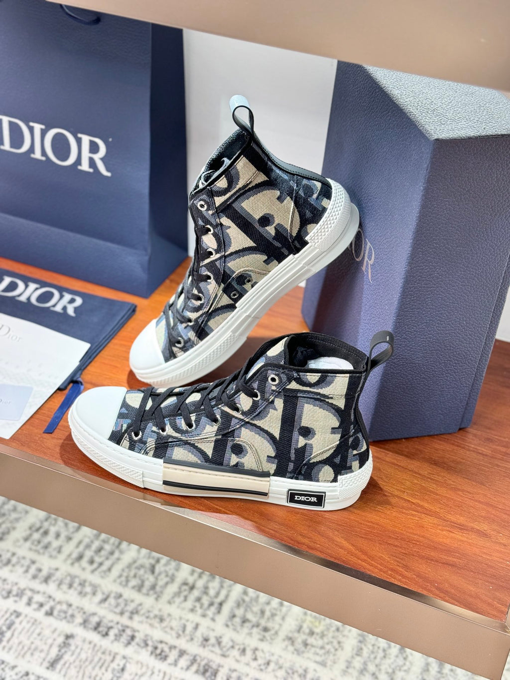Dior ladies high-top sneakers, close side angle, black-and-beige patterned canvas